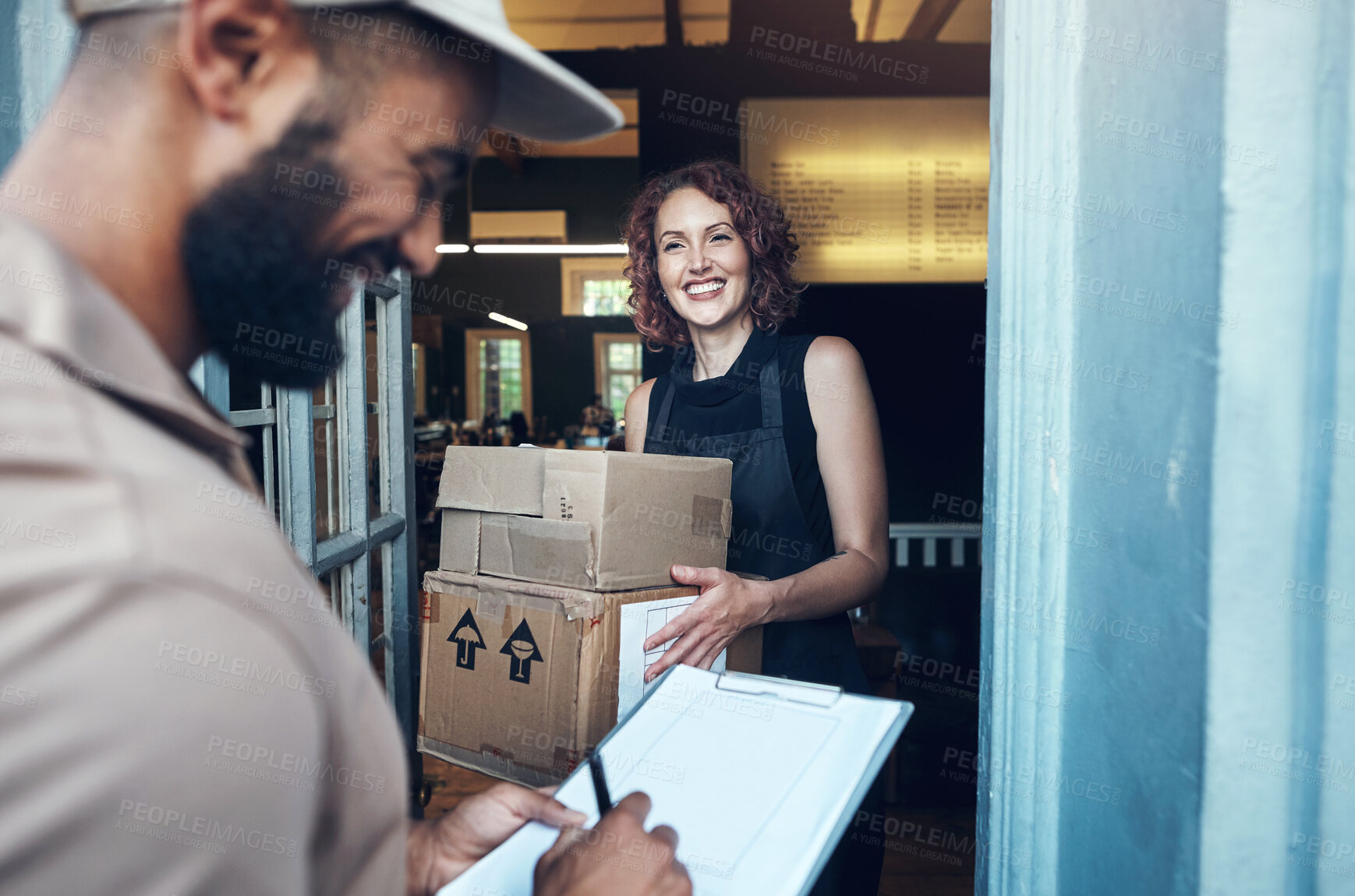 Buy stock photo Shot of an attractive young hairdresser receiving a delivery from the courier at her salon