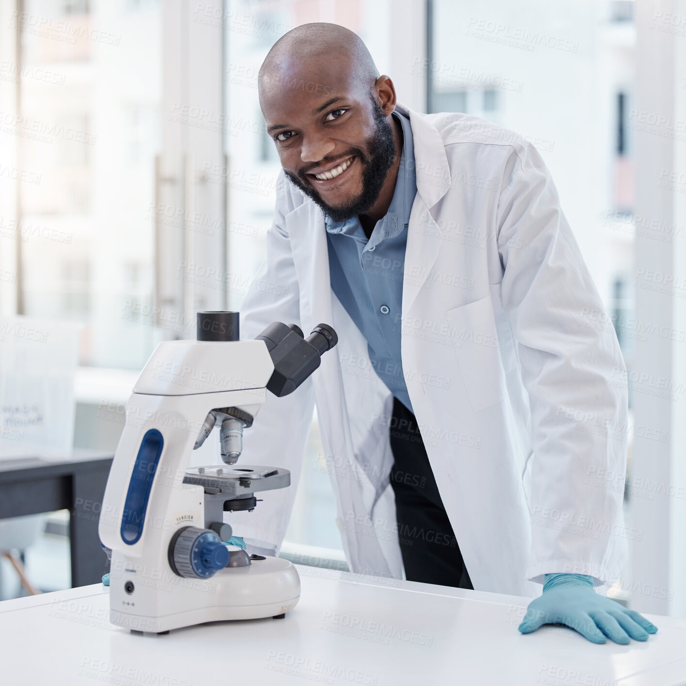 Buy stock photo Shot of a young scientist using a microscope in a laboratory