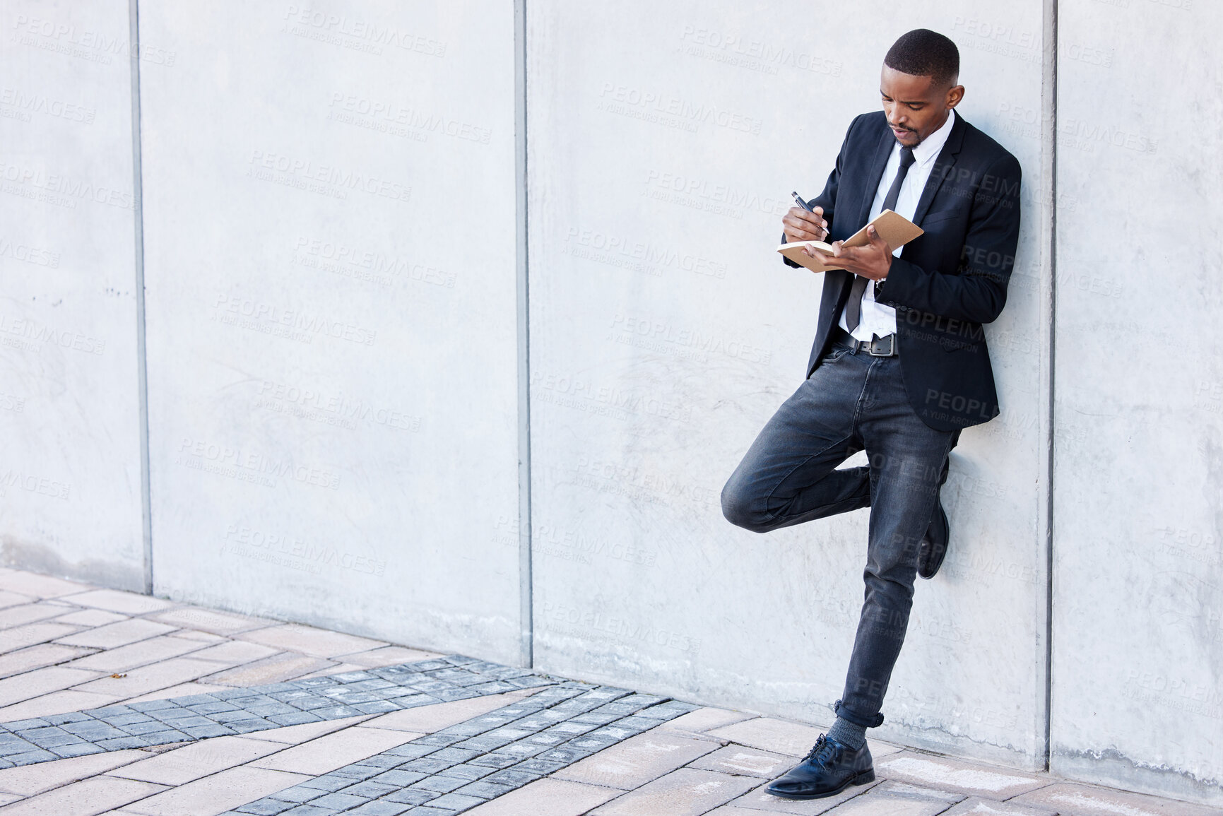 Buy stock photo Businessman, notebook and writing in outside to relax by wall of office building for planning in startup. Entrepreneur, resilience and strategy for success in street with professional for work