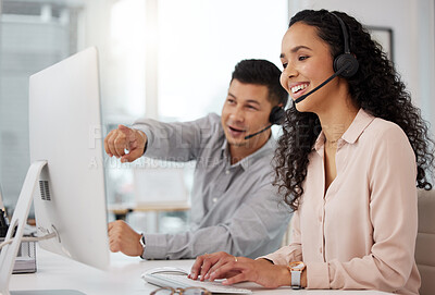 Buy stock photo Shot of two call centre agents working together on a computer in an office