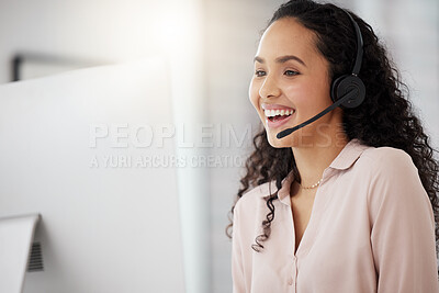 Buy stock photo Shot of a young call centre agent working on a computer in an office