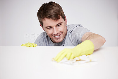 Buy stock photo Man, cleaning and home and kitchen counter, happy and wipe with cloth or disinfectant cleaner for germs maintenance. Apartment, housework and health safety, hygiene and glove for bacteria protection