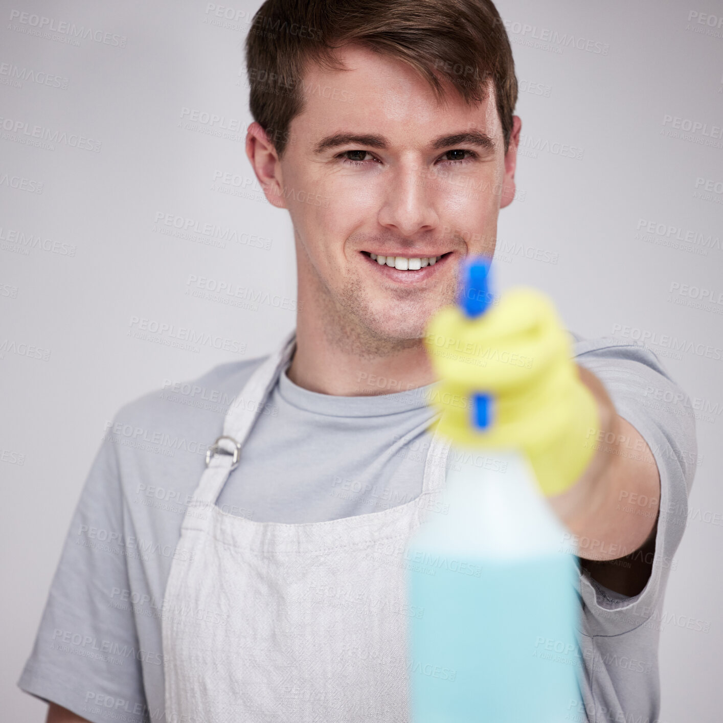 Buy stock photo Man, portrait and studio for cleaning with spray bottle, happy and disinfectant liquid cleaner for germs maintenance. Health, safety and hygiene, glove for bacteria protection on background