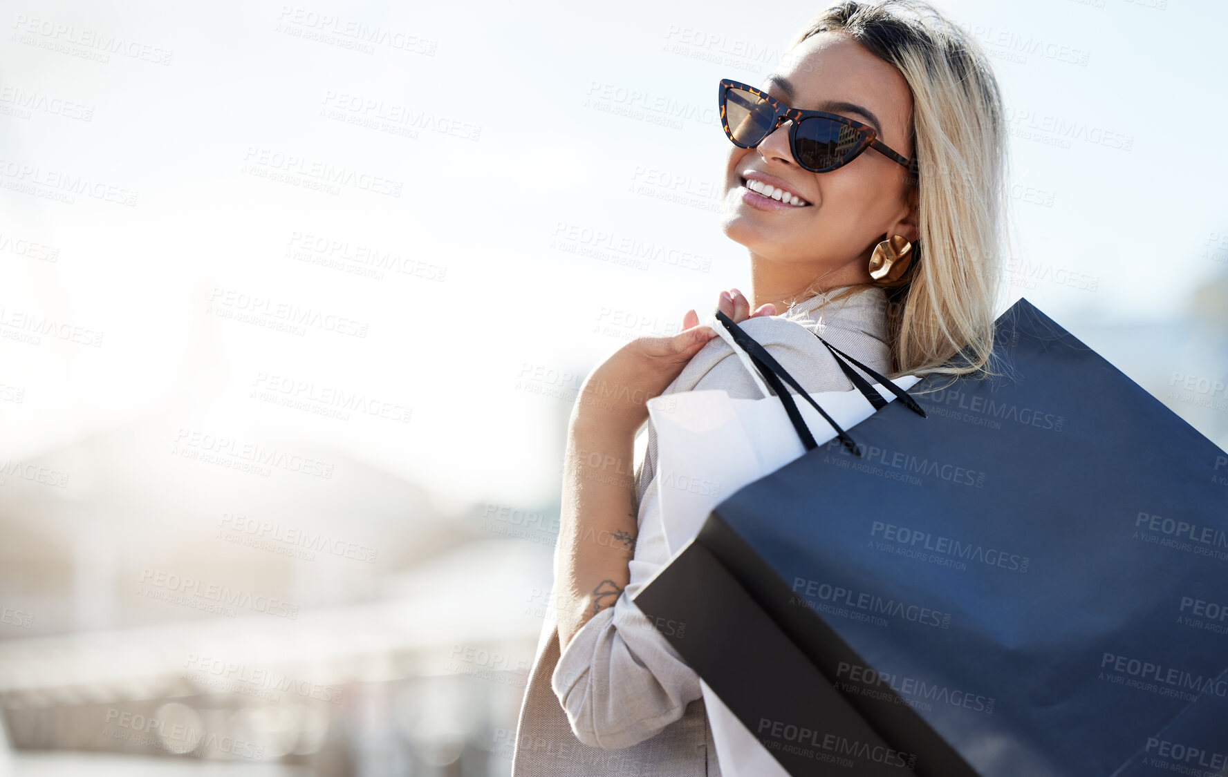 Buy stock photo Woman, shopping bags and smile with sunglasses in portrait with retail therapy for purchase with buying. Mockup space, happiness and confidence with relax on weekend in city with pride for spending