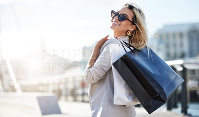 Buy stock photo Woman, shopping bags and smile with sunglasses in outside with retail therapy for purchase with buying. Travel, confidence and happiness with relax in London with city for pride with spending