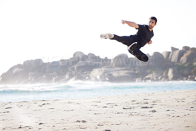 Buy stock photo Full length shot of a handsome young male athlete working out on the beach