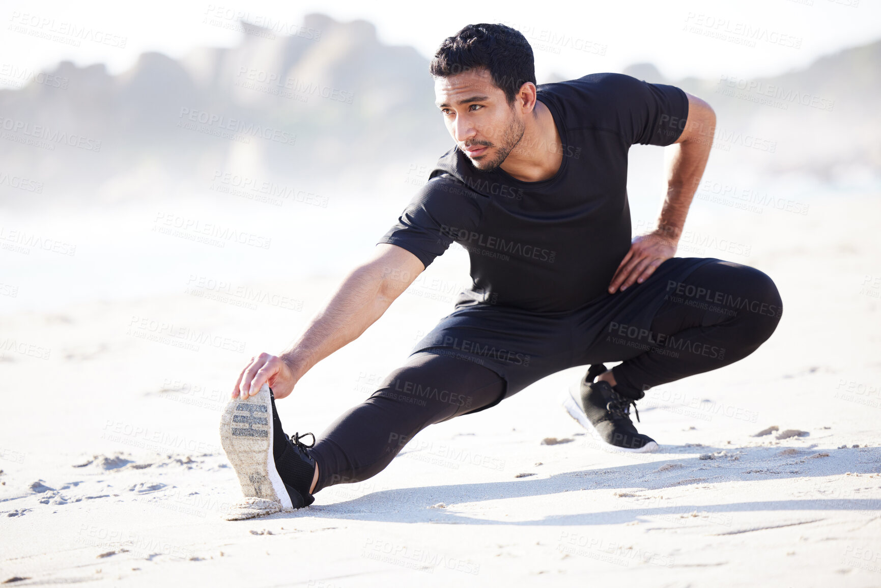 Buy stock photo Asian man, leg and fitness with stretching at beach for exercise, training and workout in morning. Male person, serious and athlete in nature for cardio warm up, flexibility and preparation on sand
