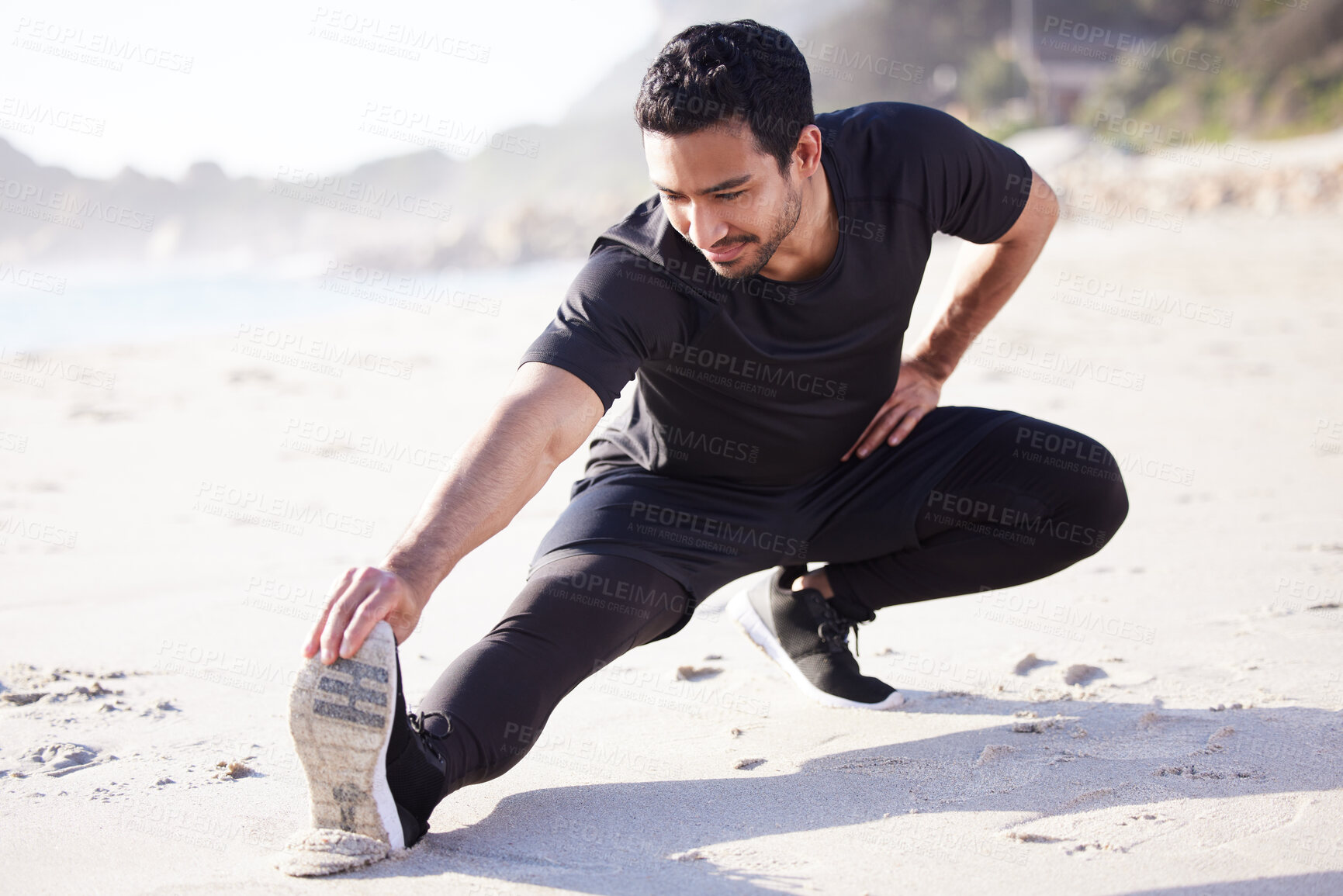 Buy stock photo Man, leg and fitness with stretching on sand for training, exercise and body workout in nature. Male person, thinking and athlete at beach for preparation, flexibility and cardio warm up in morning