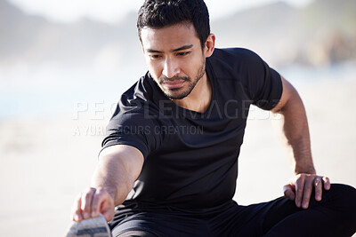 Buy stock photo Cropped shot of a handsome young male athlete warming up before his workout on the beach