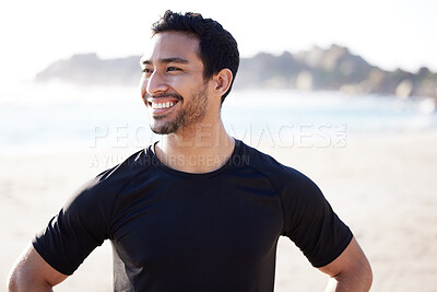 Buy stock photo Cropped shot of a handsome young male athlete looking thoughtful while working out on the beach