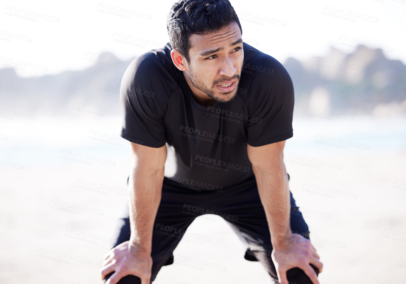 Buy stock photo Exercise, tired and Asian man with break at beach for fitness, training and sports for body health. Male runner, breathe and exhausted from workout with cardio, recovery and run fatigue in nature