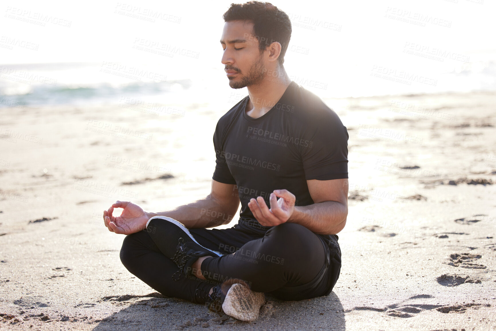 Buy stock photo Spiritual, meditation and man on beach with yoga, mindfulness or self care for healthy mindset. Calm, routine and person breathing with holistic wellness for zen chakra or aura in summer at ocean