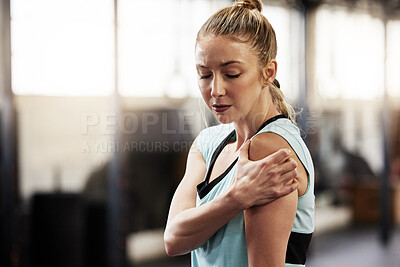 Buy stock photo Shot of a young woman suffering from an injury while at the gym