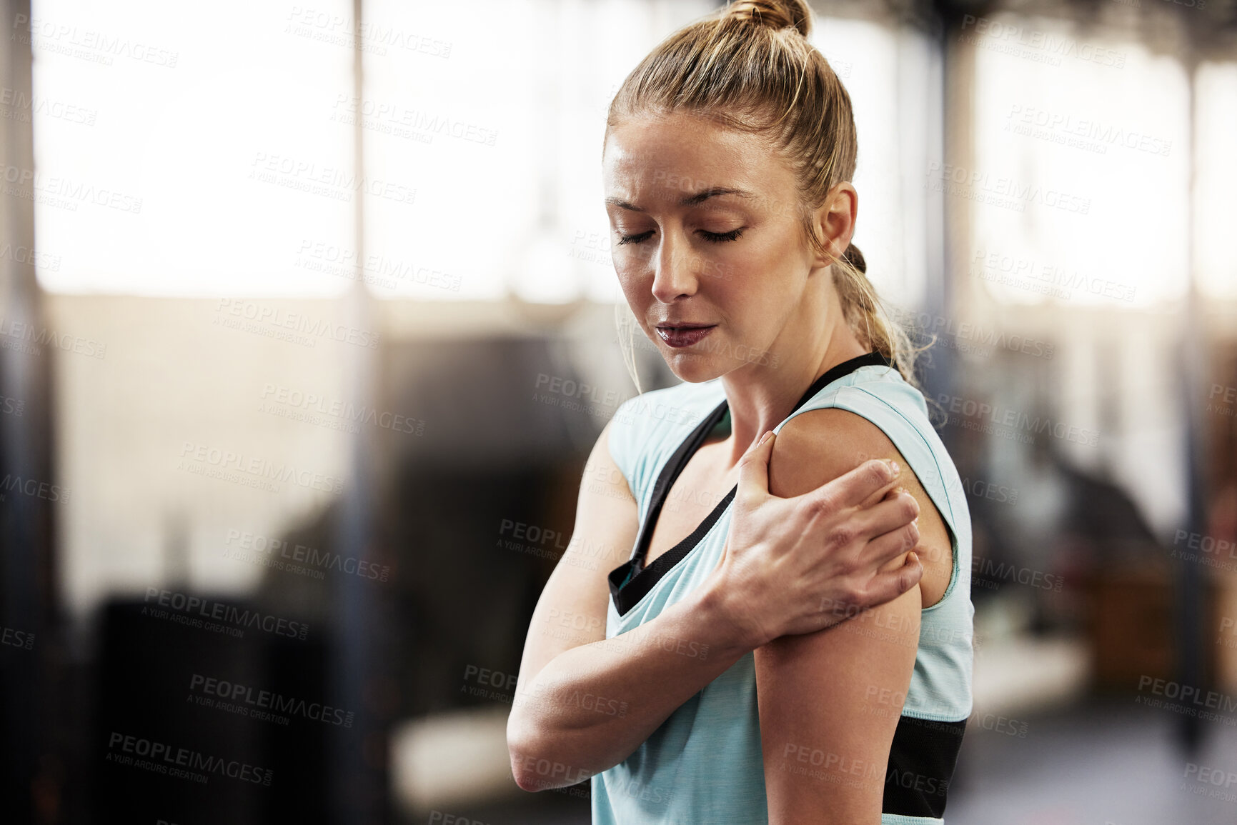 Buy stock photo Woman, gym and shoulder pain from exercise or muscle strain for fitness injury, inflammation or fibromyalgia. Female person, hand and hurt arm with joint bruise for athlete, rehabilitation or tension