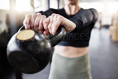 Buy stock photo Shot of a woman working out with a kettle bell