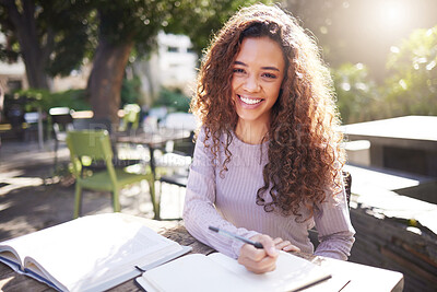 Buy stock photo Shot of a young female student studying at a cafe