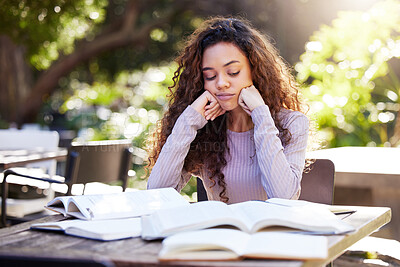 Buy stock photo Tired, woman and study books in college, education and learning at outdoor, cafe or working on park table on campus. Girl, studying and university student to work, learn or research from reading