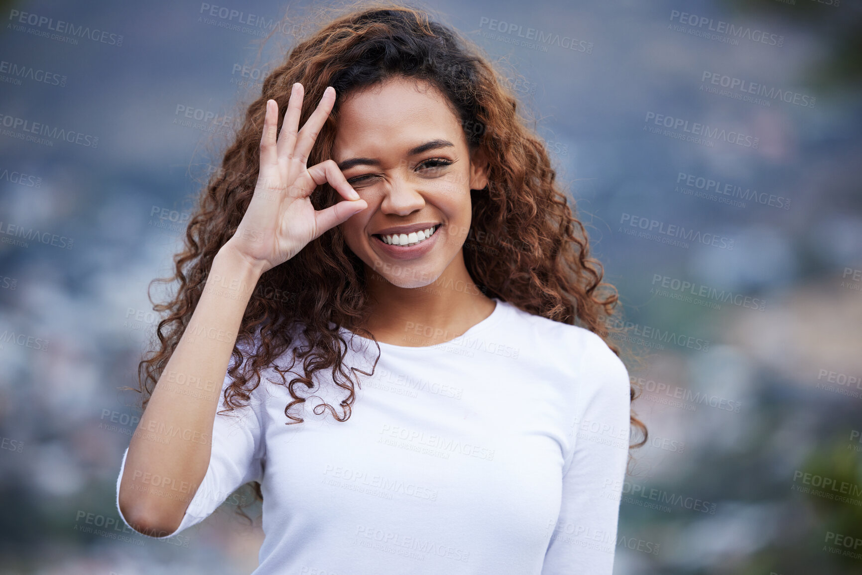 Buy stock photo Portrait, wink and fitness woman with perfect hands in nature for hiking, adventure and exercise support or motivation. Face, smile and gen z girl with OK emoji for travel, journey or wellness goals