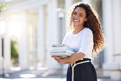 Buy stock photo Shot of a young woman carrying her schoolbooks outside at college