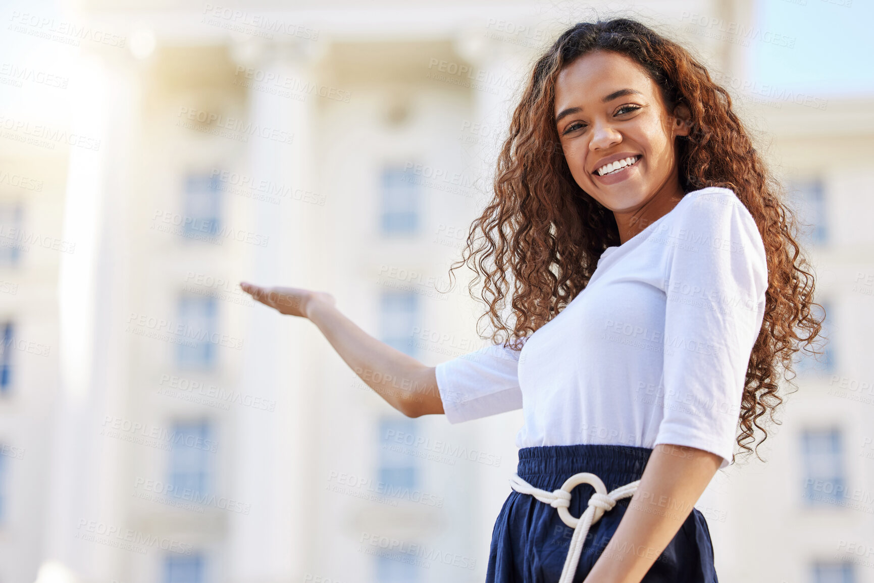 Buy stock photo Business, portrait and happy woman with hand pointing to office building for welcome, opportunity or hiring offer. Face, smile and gen z attorney intern with palm space gesture for recruitment deal