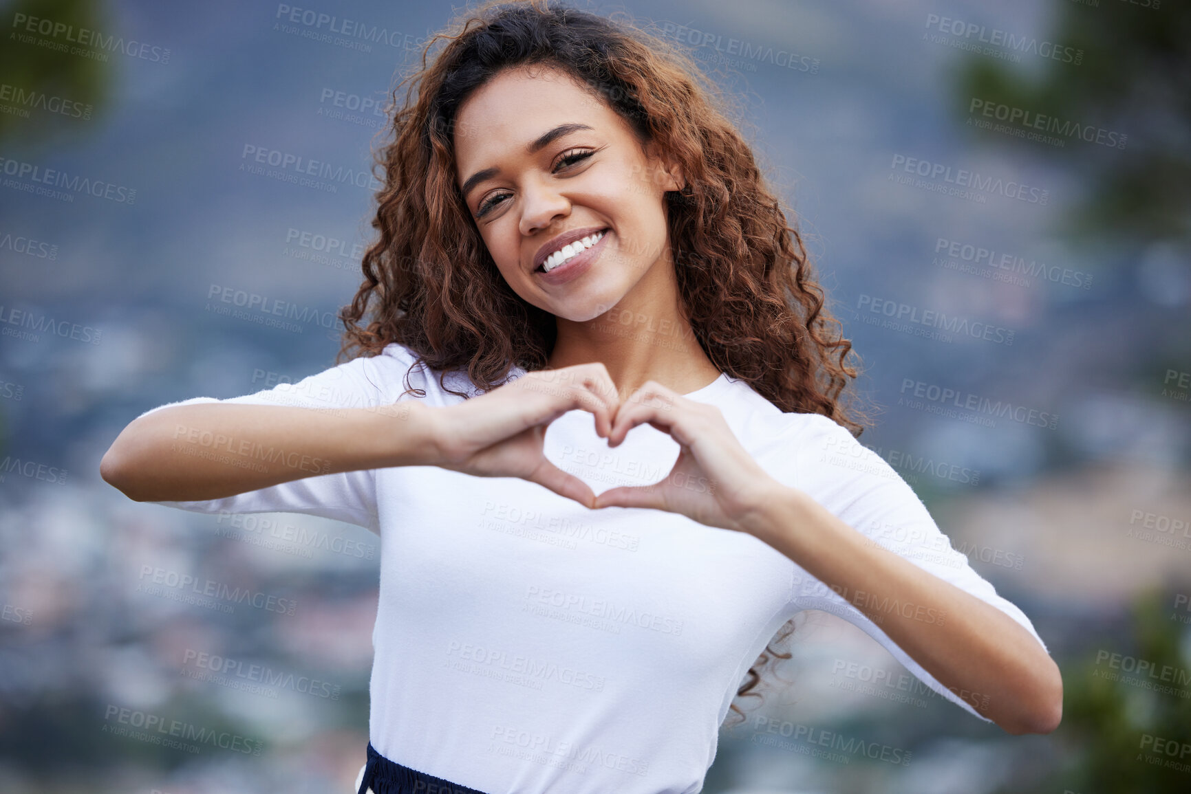 Buy stock photo Heart, hands and portrait of happy girl outdoor for travel, adventure and fun with gesture of care. Emoji, frame and gen z woman with love sign for thank you, support or London immigration experience