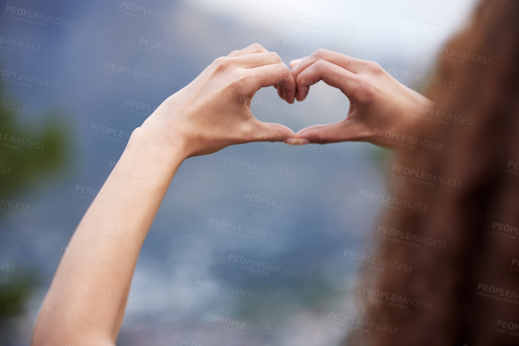 Buy stock photo Heart, hands and girl outdoor with love sign for city view, experience and holiday, trip or vacation success. Mountain, blur and woman with emoji, fingers or frame for adventure, freedom or gratitude