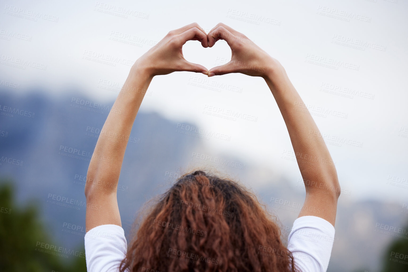 Buy stock photo Heart, hands and woman back outdoor with love sign for mountain view, experience or holiday and vacation success. Sky, blur or girl show emoji, fingers or frame for adventure, freedom or gratitude