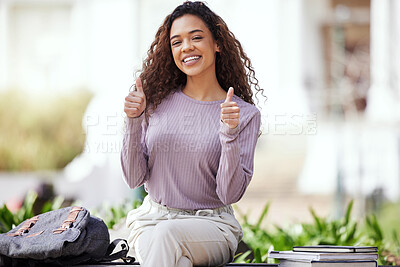 Buy stock photo Shot of a young woman showing a thumbs up while sitting in a park