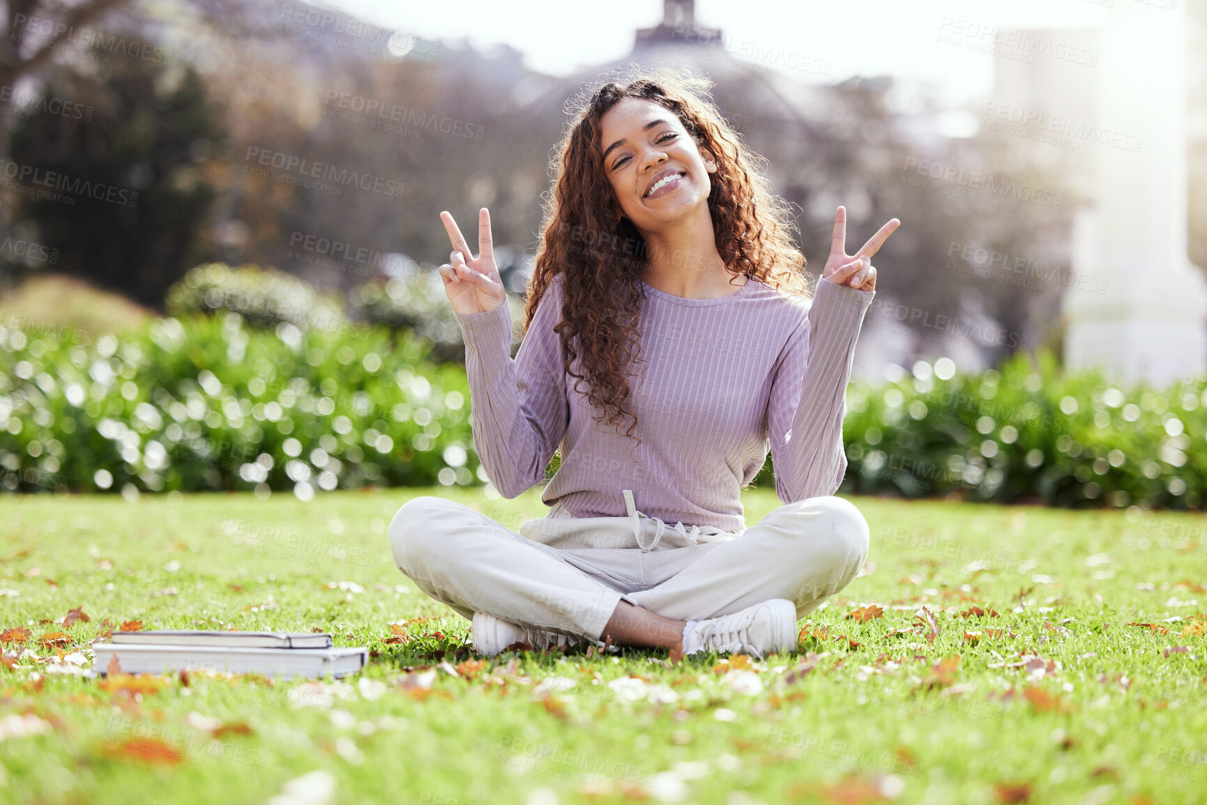 Buy stock photo Woman, college student and peace sign on grass for portrait with books, smile or studying at campus. Girl, person and happy with icon, symbol or emoji on lawn for education, learning and development