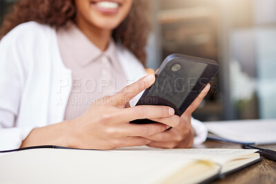Buy stock photo Shot of an unrecognizable businesswoman using a phone while working at a cafe