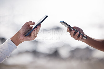 Buy stock photo Hands, friends and smartphone outdoor for connection, networking and sharing content with internet. Beach, people and cellphone for browsing, scrolling and social media with technology outside