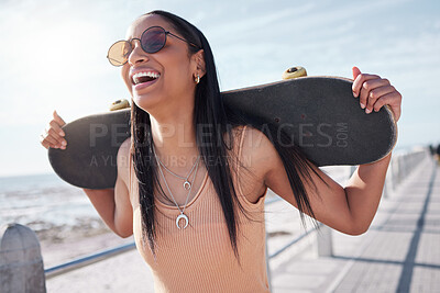 Buy stock photo Happy, summer and woman by ocean with skateboard for weekend, holiday and vacation in trendy style. Fashion, laughing and person skateboarding for activity, freedom and adventure by broadwalk seaside