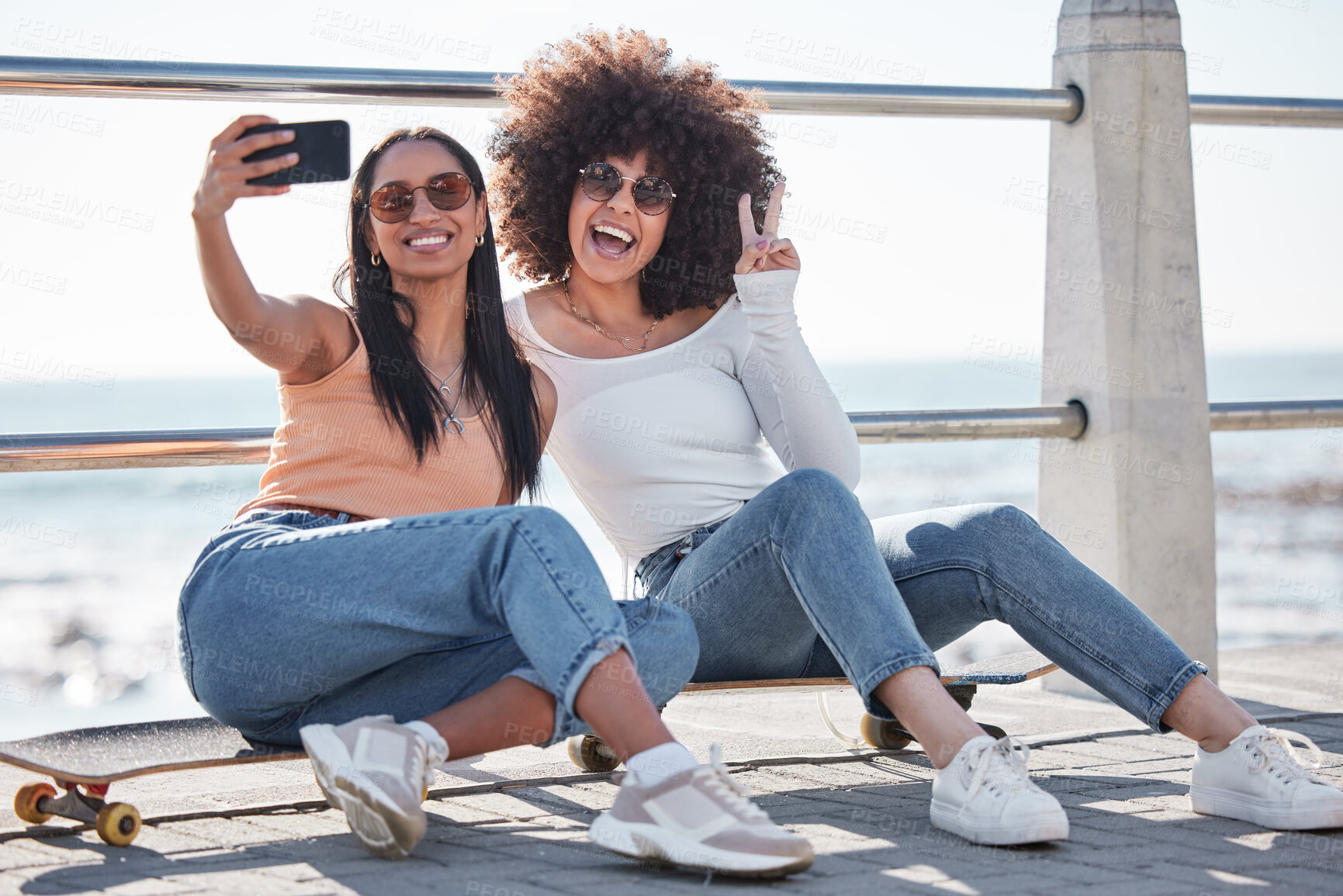 Buy stock photo Happy, friends and selfie of women in city with skateboard for weekend, holiday and vacation. Excited, promenade and people take picture on smartphone for activity, bonding and social media by ocean
