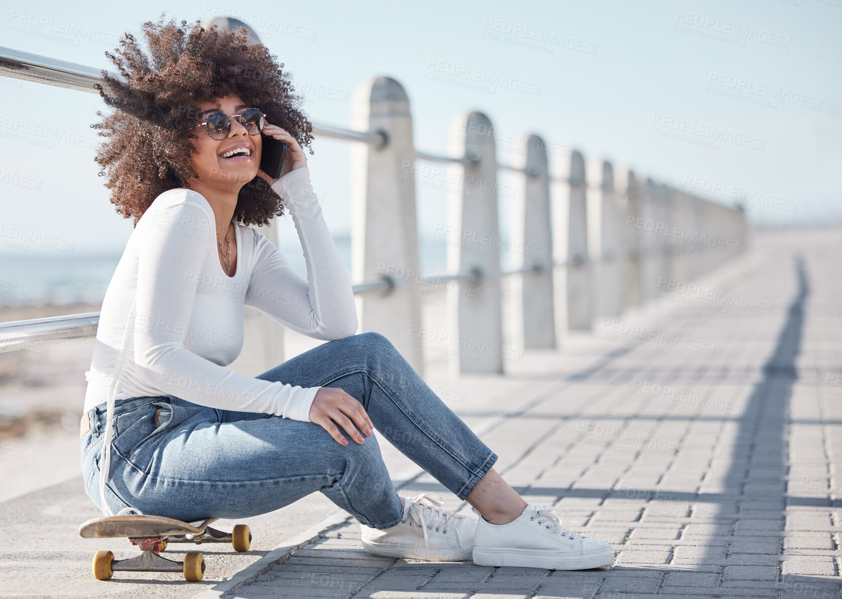 Buy stock photo Happy, laugh and black woman by ocean with skateboard for weekend, holiday and vacation in trendy style. Fashion, promenade and person skateboarding for activity, freedom and adventure by seaside