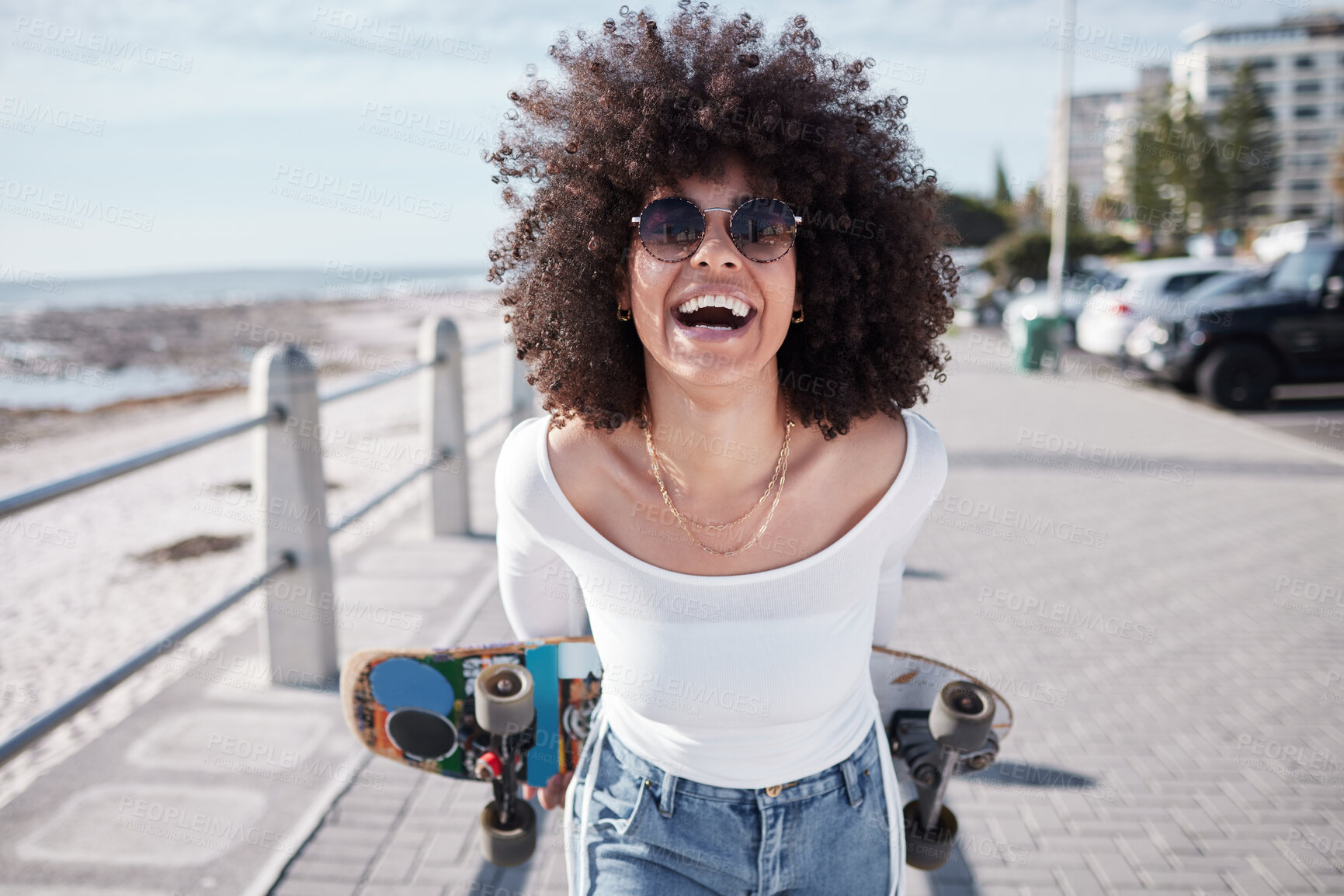 Buy stock photo Woman, happy and outdoor with a skateboard for travel, adventure and freedom on a beach road. Face of comic african person laugh on promenade for tropical vacation or skating with sunglasses in Miami