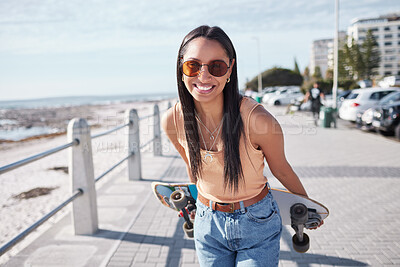 Buy stock photo Happy, portrait and woman by ocean with skateboard for weekend, holiday and vacation in trendy style. Fashion, summer and person skateboarding for activity, freedom and adventure by broadwalk seaside