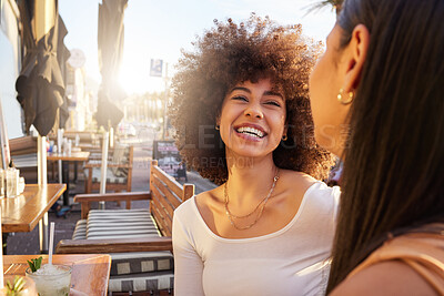 Buy stock photo Shot of two friends catching up while having drinks at a bar outside