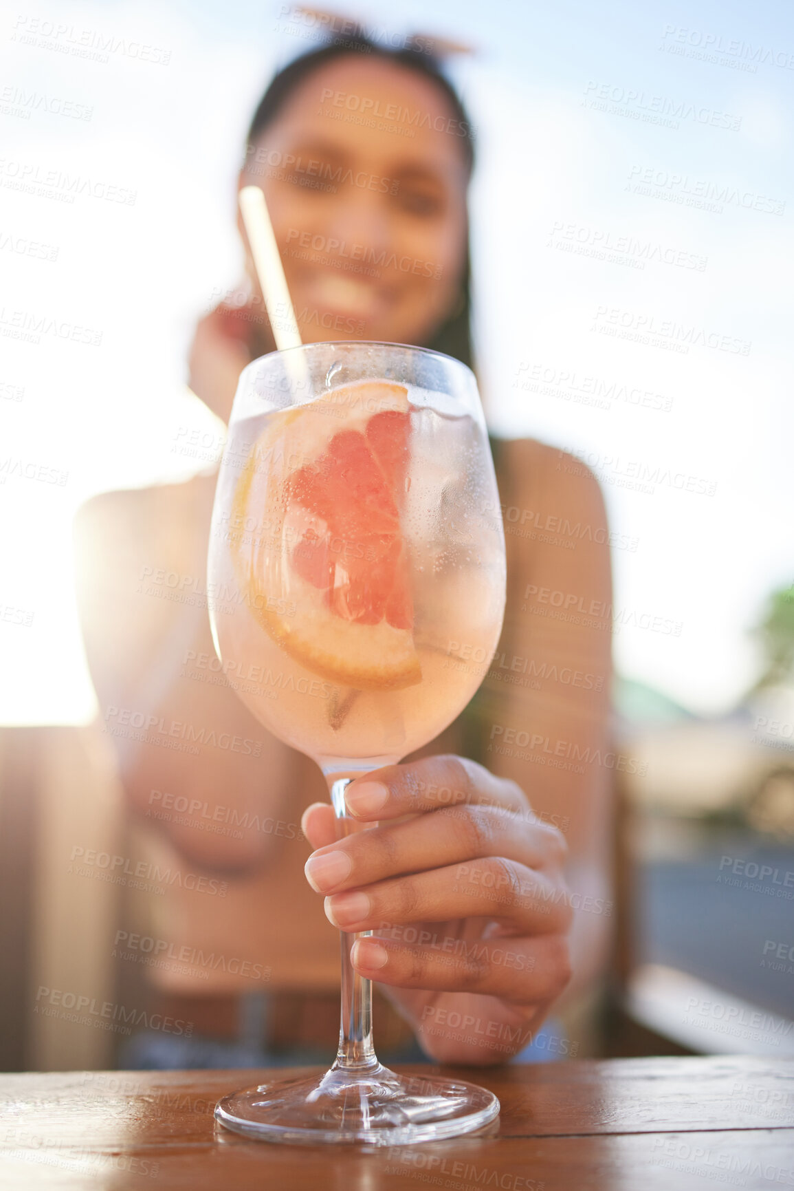 Buy stock photo Portrait of a beautiful young woman having a drink at a bra outside