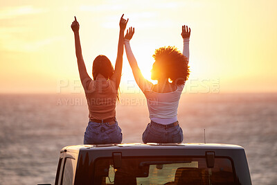 Buy stock photo Sunset, women sitting on a car and at the beach with back view for carefree or peace. Freedom or adventure, summer vacation or holiday break and travel with female people at sea happy together