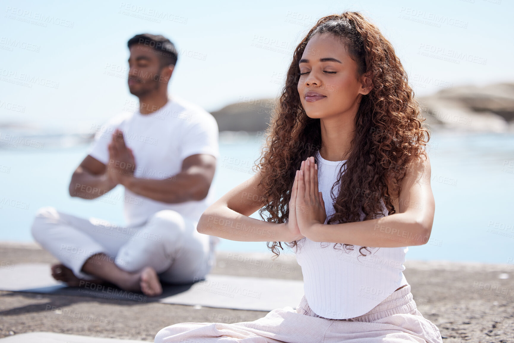 Buy stock photo Couple, yoga and ocean with calm, peace and zen gesture with meditation and wellness outdoor. Nature, healthy people and namaste sign with holistic and spiritual practice by the sea on a rock