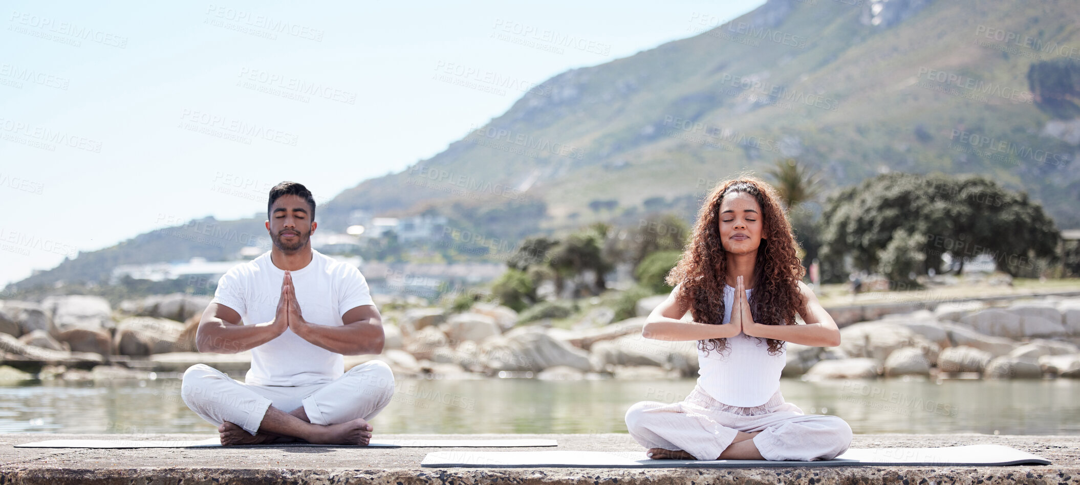 Buy stock photo Meditation, yoga and couple in prayer by ocean for spiritual mediation, holistic treatment and zen energy. Sea, nature and man and woman with praying hands for peace, calm and chakra for wellness