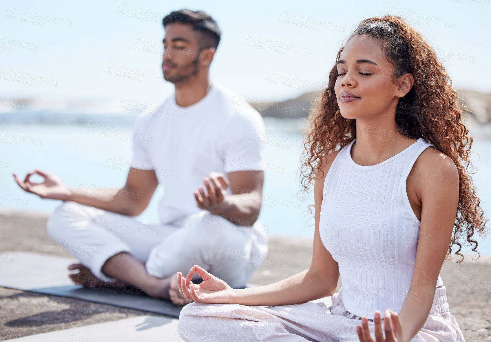 Buy stock photo Outdoor, couple and lotus pose for meditation, mindfulness and holistic wellness beach. People, man and woman with zen for bonding in California to relax, peace and mental health in relationship