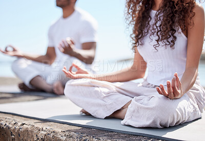 Buy stock photo Cropped shot of an unrecognizable couple practicing yoga at the beach