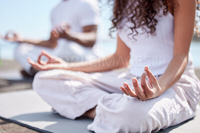 Buy stock photo Cropped shot of an unrecognizable couple practicing yoga at the beach