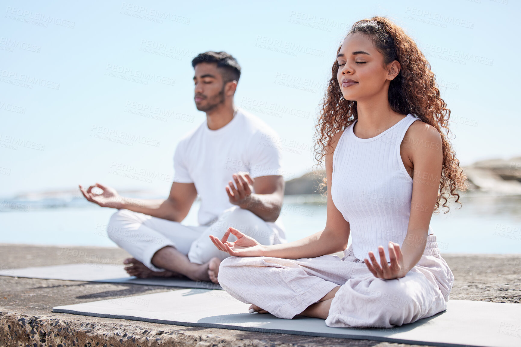 Buy stock photo Beach, couple and lotus pose for meditate, mindfulness and holistic wellness outdoor. People, man and woman with zen for bonding in California to relax, peace and mental health in relationship