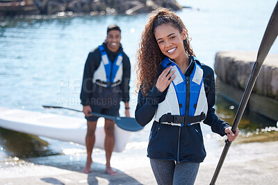 Buy stock photo Portrait of a young couple getting ready for a kayaking ride together at a lake