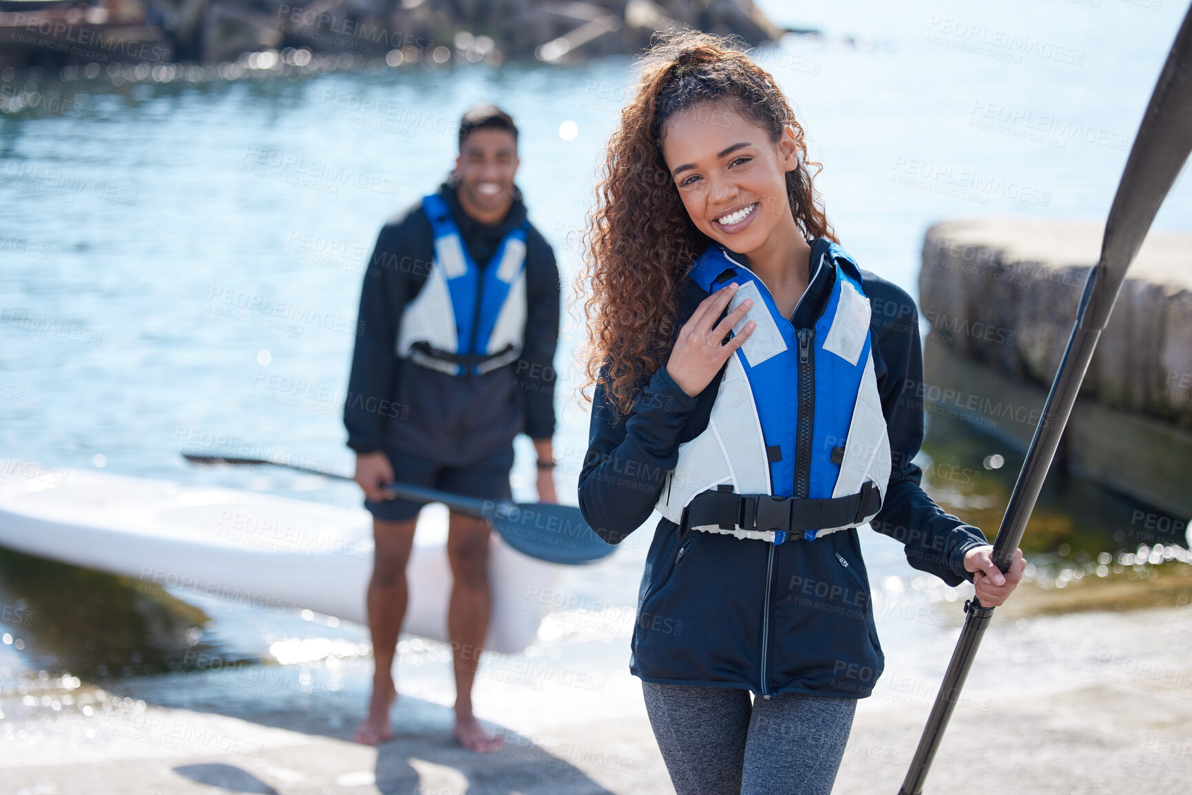 Buy stock photo Portrait of a young couple getting ready for a kayaking ride together at a lake