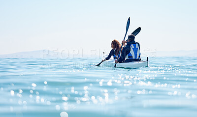 Buy stock photo Rearview shot of a young couple kayaking together at a lake