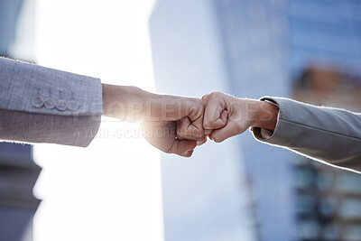 Buy stock photo Shot of two unrecognizable businesspeople giving a fist bump outside