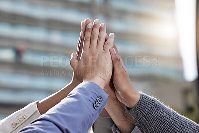 Buy stock photo Shot of a group of unrecognizable businessmen giving a high five outside